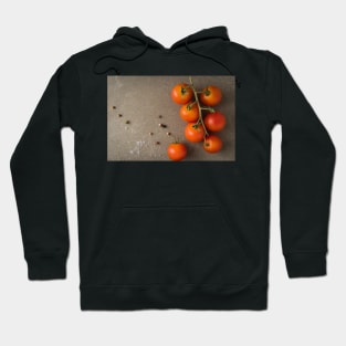 Top view of a bunch of natural cherry tomatoes on cement background with copy space Hoodie